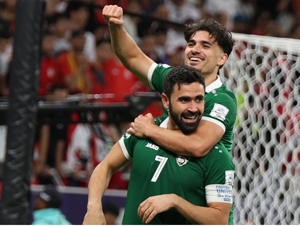 Omar Khribin (foreground) celebrates with a teammate after scoring a goal. 