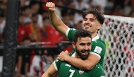 Omar Khribin (foreground) celebrates with a teammate after scoring a goal. 