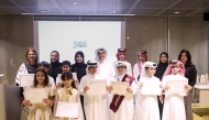 Minister of State and President of Qatar National Library H E Dr. Hamad bin Abdulaziz Al-Kawari and other officials with winners of the competition