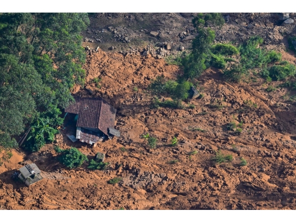 An aerial view shows a residential house lying in a shattered state at the site of a landslide in Nuwara Eliya on December 2, 2025. Photo by ISHARA S. KODIKARA / AFP