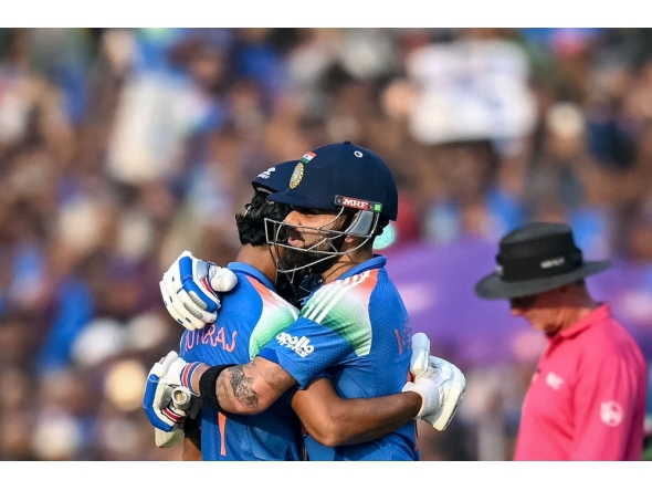 India's Virat Kohli (R) congratulates Ruturaj Gaikwad as he celebrates after scoring a century (100 runs) in Raipur on December 3, 2025. (Photo by Noah Seelam / AFP) 