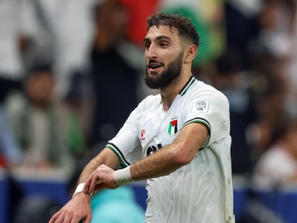 Palestines' Zeid Qunbar celebrates after scoring the equaliser.