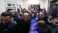 Palestinians mourn over the body of Bahaa Rashed at Rafidia hospital in Nablus after he was killed during an operation by Israeli forces in the village of Odala, south of Nablus in the occupied West Bank, on December 5, 2025. (Photo by JAAFAR ASHTIYEH / AFP)