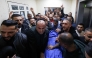 Palestinians mourn over the body of Bahaa Rashed at Rafidia hospital in Nablus after he was killed during an operation by Israeli forces in the village of Odala, south of Nablus in the occupied West Bank, on December 5, 2025. (Photo by JAAFAR ASHTIYEH / AFP)