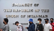 Myanmar nationals living in Thailand queue up outside the Myanmar Embassy for early voting ahead of the Myanmar general election, in Bangkok on December 6, 2025. (Photo by Lillian Suwanrumpha / AFP)
 