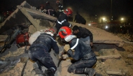 Emergency personnel search for victims in the rubble of two collapsed buildings in the Al Massira area of Fes late on December 9, 2025. (Photo by Ahmed Alaoui Mrani / AFP)
