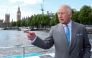 (Files) Britain's King Charles III gestures as he travels aboard the hybrid vessel 'Mars Clipper' on the River Thames on May 7, 2025. (Photo by Toby Melville / Pool / AFP)
 