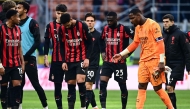 AC Milan's French goalkeeper #16 Mike Maignan(R) reacts at the end of the Italian Serie A football match between AC Milan and Sassuolo at the San Siro Stadium in Milan on December 14, 2025. (Photo by Piero CRUCIATTI / AFP)