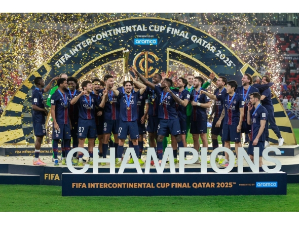 PSG's players celebrate with the trophy after winning the 2025 FIFA Intercontinental Cup final football match between Paris Saint-Germain (PSG) and CR Flamengo at the Ahmad bin Ali Stadium in Al-Rayyan on the outskirts of Doha on December 17, 2025. (Photo by Karim JAAFAR / AFP)