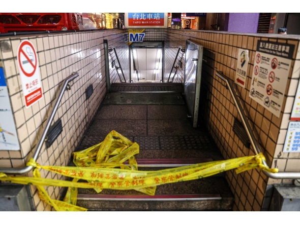 This picture taken and released by Taiwan's Central News Agency (CNA) on December 19, 2025 shows one of the entrances to Taipei Main Station being cordoned off. (Photo by Cheng Ching-Yuan / Central News Agency (CNA) / AFP) 