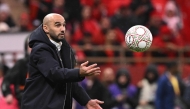Morocco's head coach Walid Regragui throws a ball during the Africa Cup of Nations (CAN) group A football match between Morocco and Comoros at Prince Moulay Abdellah Stadium in Rabat on December 21, 2025. (Photo by Sebastien Bozon / AFP)