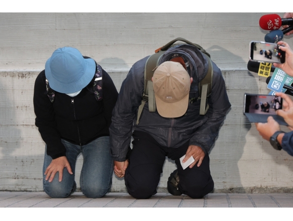 This picture taken and released by Taiwan's Central News Agency (CNA) on December 23, 2025, shows the parents of the suspect in the December 19 Taipei metro stabbings. (Photo by Weng Rui Kun / Central News Agency (CNA) / AFP)