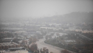 The Los Angeles river with a high water level is seen from Elysian Park on December 24, 2025 in Los Angeles, California. (Photo by Apu GOMES / AFP)
