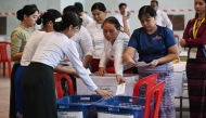 Members of Myanmar Union Election commission (UEC) count ballots after the closing of polls at a polling station in the first phase of Myanmar general election in Yangon on December 28, 2025. (Photo by Lillian Suwanrumpha/ AFP)