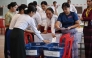 Members of Myanmar Union Election commission (UEC) count ballots after the closing of polls at a polling station in the first phase of Myanmar general election in Yangon on December 28, 2025. (Photo by Lillian Suwanrumpha/ AFP)