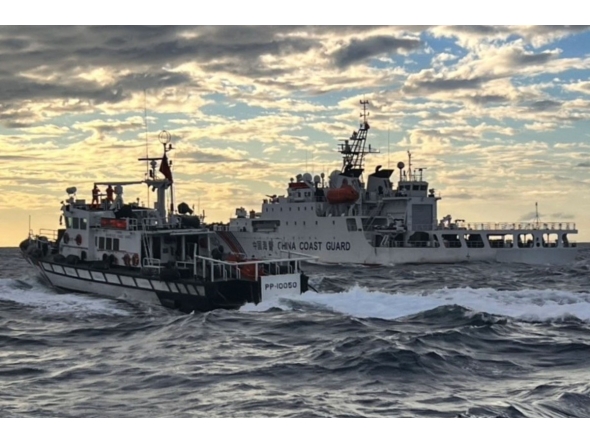 This is a handout photo taken on December 29, 2025 and released on December 30, 2025 by the Taiwan Coast Guard shows a Taiwanese coast guard ship (L) sending warnings to a Chinese coast guard ship in the waters off Taiwan's Cape Fugui. Photo by Handout / TAIWAN COAST GUARD / AFP