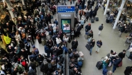 Travellers are pictured at St. Pancras station in London on December 30, 2025, as Eurostar train service between Britain and continental Europe is halted. Eurostar advised passengers to postpone their journeys to a later date, citing 