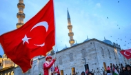 A man waves a Turkish flag as people demonstrate in solidarity with the Palestinian people amid the ongoing war in the Gaza  at the Galata Bridge in Istanbul on January 1, 2026. (Photo by Yasin Akgul / AFP)