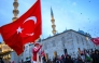 A man waves a Turkish flag as people demonstrate in solidarity with the Palestinian people amid the ongoing war in the Gaza  at the Galata Bridge in Istanbul on January 1, 2026. (Photo by Yasin Akgul / AFP)