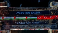 This aerial picture shows thousands of people demonstrating their solidarity with the Palestinian people at the Galata Bridge in Istanbul on January 1, 2026. (Photo by Yasin AKGUL / AFP)
