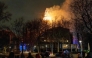 People look at the tower of the Vondelkerk church on fire during New Year's Eve, in Amsterdam on January 1, 2026. (Photo by Laurens Niezen / ANP / AFP)