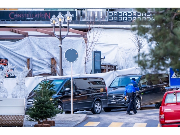 Funeral service vehicles arrive near the place where a fire ripped through the venue during New Year's Eve celebrations in Switzerland on January 1, 2026. \(Photo by MAXIME SCHMID / AFP) / ALTERNATE CROP