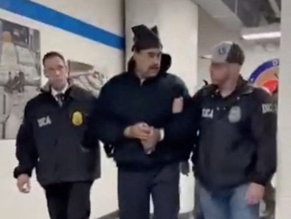 This screengrab taken from the X account of Rapid Response 47, the official White House rapid response account, shows Venezuelan President Nicolas Maduro (C) escorted by DEA agents inside the headquarters of the US Drug Enforcement Administration (DEA) in lower Manhattan, New York, on January 3, 2026. (Photo by X account of Rapid Response 47 / AFP)