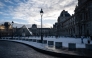 This photograph shows a general view of the Louvre Museum, with the Louvre pyramid (L) designed by Chinese-US architect Ieoh Ming Pei, after the first snowfall of the year in Paris on January 3, 2026. (Photo by Blanca CRUZ / AFP)