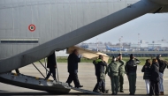 The coffins of four Italian nationals killed in the New Year's fire disaster at Le Constellation in the Alpine ski resort town of Crans-Montana in Switzerland, are carried on the tarmac after the landing of Italian Air Force C130 at Linate Milan airport on January 5, 2026. Photo by MATTEO CORNER / ANSA / AFP