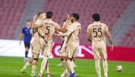 Al Rayyan's Roger Guedes (left) celebrates with teammates.