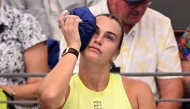Aryna Sabalenka of Belarus places an ice pack on her head during her women's singles match against Sorana Cirstea of Romania at the Brisbane International tennis tournament in Brisbane on January 8, 2026. (Photo by William WEST / AFP)