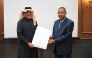 Director General of the Qatar Press Center Sadiq Mohammed Al-Amari (left) honouring former Sudanese Minister of Foreign Affairs, and Professor of Islamic Studies at Hamad Bin Khalifa University Dr. Mustafa Osman Ismail. 