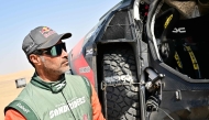 Nasser Al Attiyah stands next to his car after competing in Stage 9. PIC: AFP 