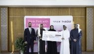 Qatar Airways representatives handing over the funds to QCS. 