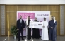 Qatar Airways representatives handing over the funds to QCS. 