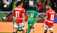 Egypt's forward #10 Mohamed Salah celebrates after the Africa Cup of Nations (CAN) semi-final football match between Senegal and Egypt at the Grand stadium in Tangiers on January 14, 2026. (Photo by SEBASTIEN BOZON / AFP)