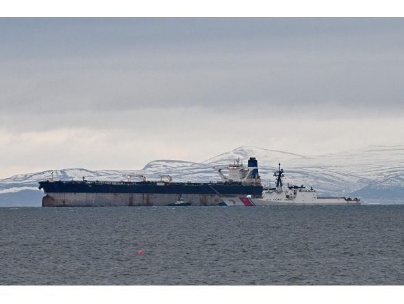 An oil tanker formerly known as the Bella-1, before it changed its name to the Marinera, is pictured alongside a US coast guard ship, at sea in the Moray Firth, northern Scotland, on January 14, 2026. (Photo by Andy Buchanan/ AFP)