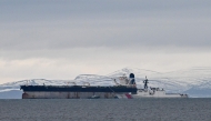 An oil tanker formerly known as the Bella-1, before it changed its name to the Marinera, is pictured alongside a US coast guard ship, at sea in the Moray Firth, northern Scotland, on January 14, 2026. (Photo by Andy Buchanan/ AFP)