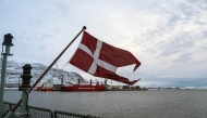 The Danish flag flies form the deck of the HDMS Knud Rasmussen Royal Danish Navy patrol vessel, moored at the harbour in Nuuk, Greenland on January 16, 2026. (Photo by Alessandro Rampazzo/ AFP)
