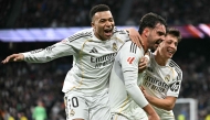 Real Madrid's Spanish defender #17 Raul Asencio (C) celebrates with Real Madrid's French forward #10 Kylian Mbappe (L) and Real Madrid's Turkish midfielder #15 Arda Guler after scoring his team's second goal during the Spanish league football match between Real Madrid CF and Levante UD at Santiago Bernabeu Stadium in Madrid on January 17, 2026. (Photo by Javier SORIANO / AFP)