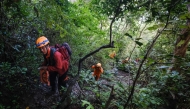 Joint search and rescue teams climb towards the suspected crash site of an Indonesia Air Transport turboprop plane in the Bulusaraung Mountains, South Sulawesi, Indonesia, January 18, 2026. (Photo by Muchtamir / AFP)