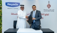 Director General of the Qatar Press Centre Sadiq Mohammed Al-Amari  and Director General of Al-Riyada Medical Centre Jamshir Hamza  exchanging documents after signing the agreement.