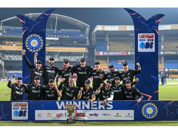 New Zealand's players celebrate with the trophy after winning the series and the third ODI cricket match between India and New Zealand at the Holkar cricket Stadium in Indore on January 18, 2026. (Photo by Indranil MUKHERJEE / AFP)