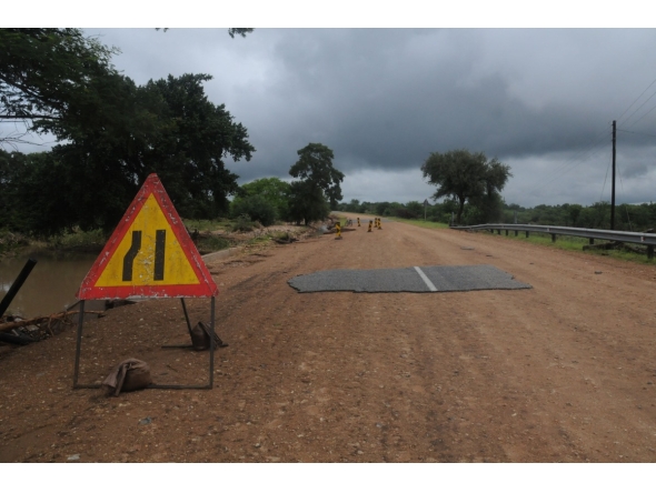 A general view of a damaged road on the way from Giyani to Mbaula on January 17, 2026 following heavy rains over much of the Limpopo Province, South Africa (Photo by LUCAS LEDWABA / AFP)
