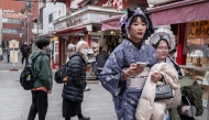 People visit a shopping street in Asakusa district near Sensoji Temple, a popular tourist location in Tokyo on January 20, 2026. (Photo by Philip Fong / AFP)
 