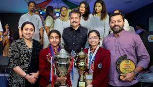 Students and teachers of Bhavan’s Public School pose with the trophies.
