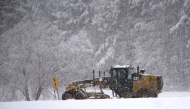 A snow plow moves along Wade Avenue as snow falls on January 17, 2018 in Raleigh, North Carolina. Lance King/Getty Images/AFP