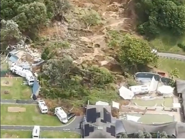 This screen grab made from UGC footage shows the site of a landslide in Mount Maunganui. A landslide smashed into a campsite in rain-swept northern New Zealand on January 22, leaving multiple people missing under tonnes of mud. (Photo by Handout / Amy Till, Solsea Swim / AFP) 