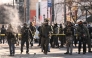 Federal agents stand near police tape as demonstators gather near the site of where state and local authorities say a man was shot by federal agents earlier in the morning in Minneapolis, Minnesota, on January 24, 2026. (Photo by ROBERTO SCHMIDT / AFP)