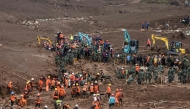 Rescuers search for victims buried by a landslide in Pasirlangu village in Bandung, West Java, on January 26, 2026. (Photo by Timur Matahari / AFP)